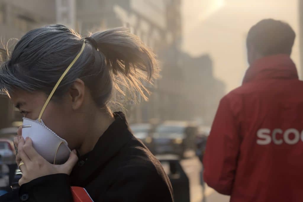 A woman wearing a protective face mask during poor air quality event affecting San Francisco.