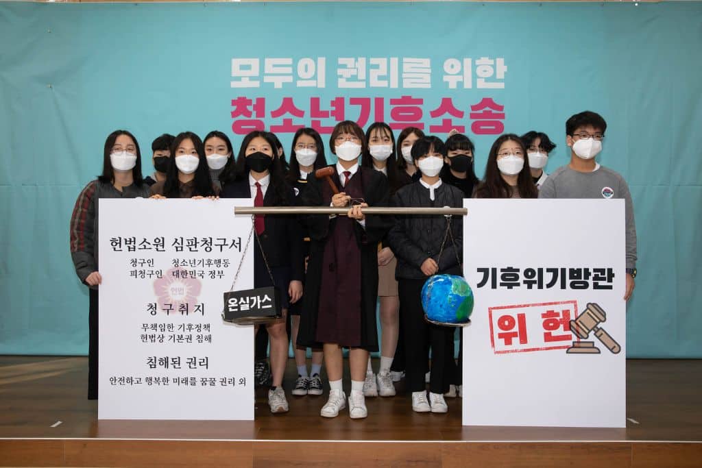 Young activists during a press conference in 2020 following the filing of the litigation. Hyunjung Yoon is in the middle, holding the judge's gavel.